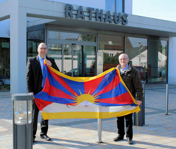 Bürgermeister Klaus Schejna und der Erste Beigeordnete Helmut Schwindt mit der Tibetflagge